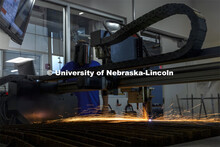 Jerry Reif, shop manager at Nebraska Innovation Studio, watches as a plasma cutter cuts through stee