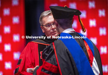 Chancellor Ronnie Green hands out each person’s diploma and talks for a moment with each new gradu