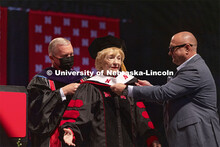 Leta Powell Drake, local television pioneer and Husker alumna, is hooded by NU Regent Tim Clare and 