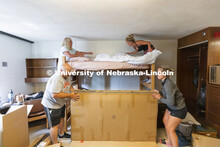 Family teamwork as Sophia Todora of Roscoe, IL, upper right, makes her bed with the help of her mom,