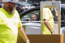 Robin Lindemann, a First Husker from Arlington, TX, watches as her belongings are unloaded from her 