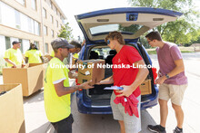 Seth Wright, a freshman from Petersburg, Nebraska, hands over a box to the move-in crew at Massengal