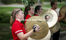 Kelly Fedderson and the rest of the cymbal line performs before the Cornhusker Marching Band Exhibit