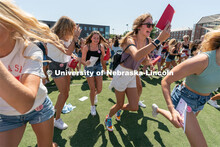 Students run to their chapter during Sorority Rush Bid on the Vine Street fields. Sorority bid day r