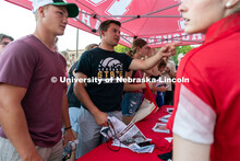Students form a large line to get free Husker merchandise during the Big Red Welcome Street Festival