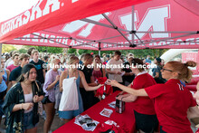 Students form a large line to get free Husker merchandise during the Big Red Welcome Street Festival