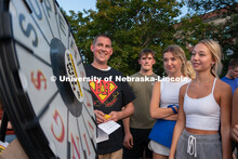 Students take turns spinning a wheel to try and win free prizes during the Big Red Welcome Street Fe