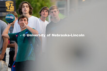 Students take turns trying to throw a basketball into a kid’s sized hoop during the Big Red Welcom