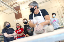 Students watch over the shoulder of Margaret Bohls, associate professor of art, so they can learn co