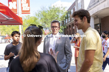 Chancellor Ronnie Green talks with students including Josh Rodriguez, left, and Ryan Thomas, right, 