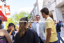 Chancellor Ronnie Green talks with students including Josh Rodriguez, left, and Ryan Thomas, right, 