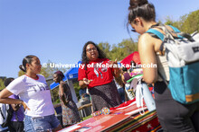 Nasia Olson-White Feather of Red Lake, MN, talks with a student at the UNITE table as Jaicein Mayfie