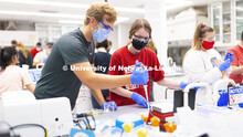 Eli Havekost and Jenna Junker, both seniors from Beatrice, pipette liquids during their Biochemistry