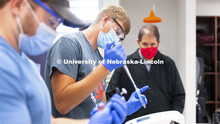 Austin Streeter, senior from West Point, Nebraska, pipettes liquids during his Biochemistry 401 lab 
