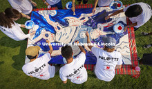 Students paint “Lift Off”, during an entrepreneurial community mural painting in the green space