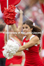 The Spirit Squad run across the field carrying the large Husker flags. Nebraska vs. Fordham Universi