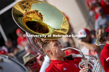 Kason Fiedler, a senior from Lincoln, plays the sousaphone as the Cornhusker Marching Band warms up 