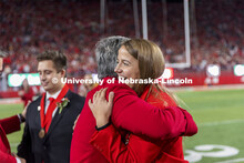 Leigh Jahnke of West Point gets a hug from Husker Jane Green after being named homecoming royalty at