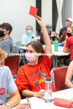 A student holds up a red card in an ALEC 102 class. Hannah Sunderman, Program Director, NHRI Leaders