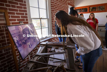 Jean Parker-Morris looks over a photo of students working in the carpentry shop. Her great grandfath