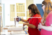 Jaidan Payer and Daelyn Zagurski look through records for their great grandfather Edward Payer who w
