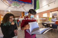 Paulina Salzman and Kayden Ramirez look over old records. Ramirez had a relative who attended the sc