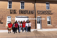 Students from the UNITE tour group pose in front of the Genoa Indian School. Students from UNITE tou