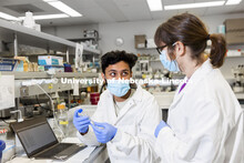 Abdullah Al Mukhaini, junior in forensic science, and lab manager Sandra Thibivilliers discuss his s