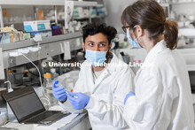 Abdullah Al Mukhaini, junior in forensic science, and lab manager Sandra Thibivilliers discuss his s