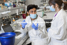 Abdullah Al Mukhaini, junior in forensic science, and lab manager Sandra Thibivilliers discuss his s