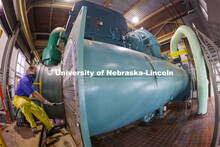 Dwayne Mischnick, a plumber/pipefitter with utility services, cleans one of the hundreds of tubes us