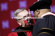 Chancellor Ronnie Green congratulates Alfonzo Cooper, Jr., a 2020 music doctorate, after his hooding