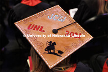 Decorated mortarboards at the Undergraduate Commencement at Pinnacle Bank Arena. December 18, 2021. 