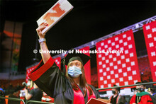 Sara Troyer shows off her CEHS Nebraska diploma to friends and family in the arena. Undergraduate Co