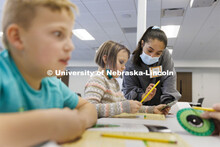 Brisa Rios, a sophomore honors student in psychology and sociology, helps 8-year-old Audrey decode a