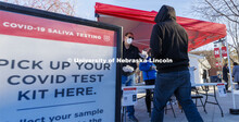Robert Kelly and other volunteers hand out testing kits to lessen waiting time at the Nebraska Union