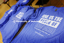 Shirts are stacked in piles for the volunteers. Volunteers are packing more than 2,000 rice and bean