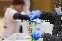 Georgia Jones, an Associate Professor of Nutrition and Health Sciences, adds a scoop of beans to a m