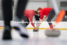 Luke Schroeder (left) Olivia Schuster (right) sweeps during curling practice at the John Breslow Ice