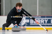 Seamus Hurley serves during curling practice at the John Breslow Ice Hockey Center. Curling Club. Fe