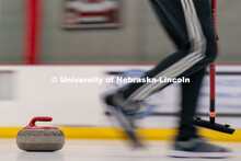 A curling stone moves across the ice at the John Breslow Ice Hockey Center. Curling Club. February 1