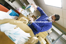 Jon Gayer, Assistant Director of Fraternity and Sorority Life, sorts masks into bags for distributio