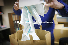 Jon Gayer, Assistant Director of Fraternity and Sorority Life, sorts masks into bags for distributio