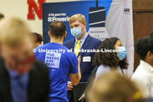 Luke Buettner talks with a Nelnet recruiter at the UNL Spring Career Fair in the Nebraska Union. Feb