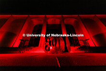 The Sheldon Memorial Art Gallery and Fallen Dreamer sculpture are bathed in red lights for Glow Big 