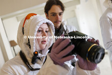 Kara Deightal and Sam Thomas look over evidence photographs. Students do crime scene investigation i