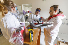 Brandy Branscom, center, and Mariya Dudin log in evidence at the crime scene. Students do crime scen