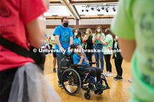 Miracle Family members who attend the marathon run through a cheering tunnel of students to start th