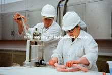 Leila Venzor and Frazier Kaelin demonstrate the sausage-making process. UNL Meat Science club had a 
