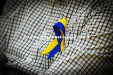 Members of the Ukrainian community in Lincoln wore blue and yellow ribbons to the event. Stand With 